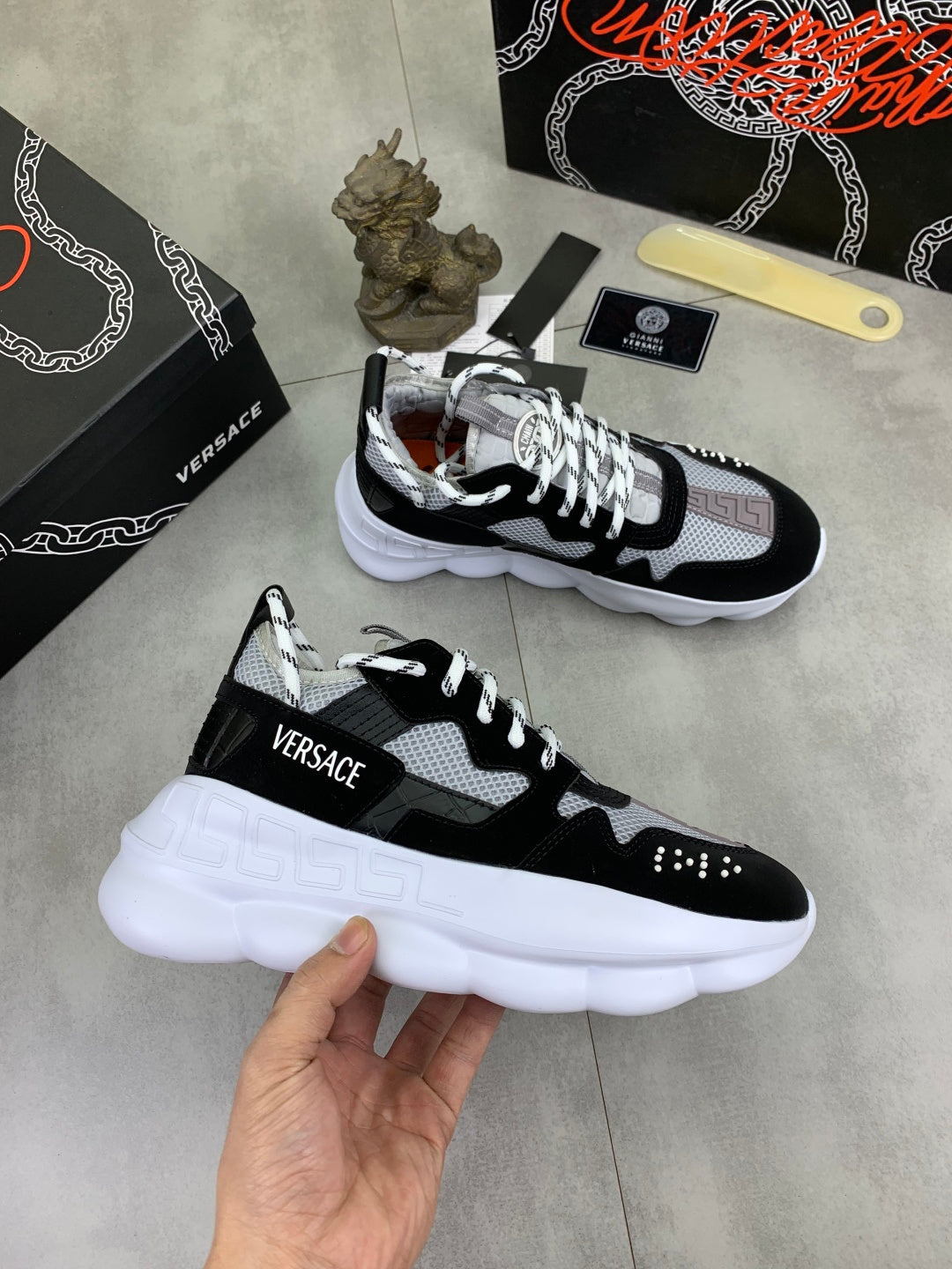 Versace low-top sneakers, black and white with thick sole and 'VERSACE' tongue label
