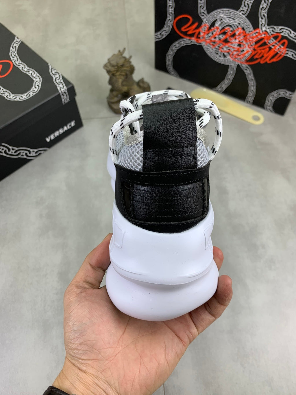 Black and white Versace sneakers heel view with cushioned white platform sole