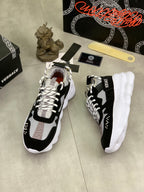 Black and white Versace sneakers with chunky white sole, side angle view
