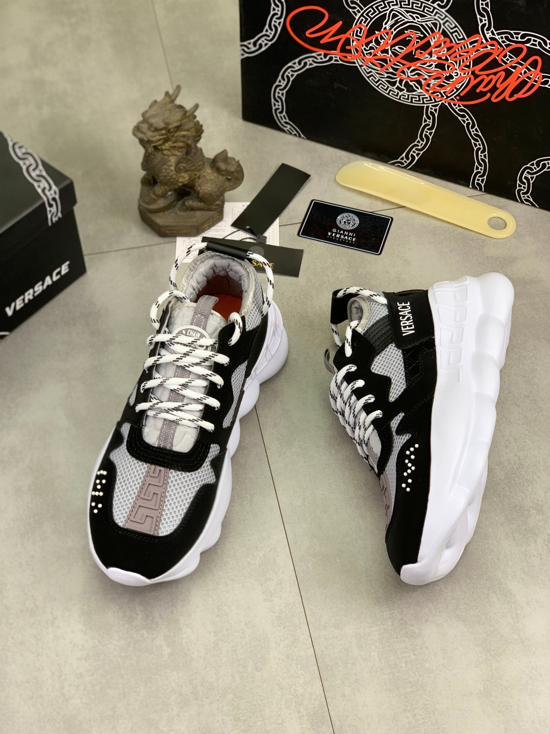 Black and white Versace sneakers with chunky white sole, side angle view