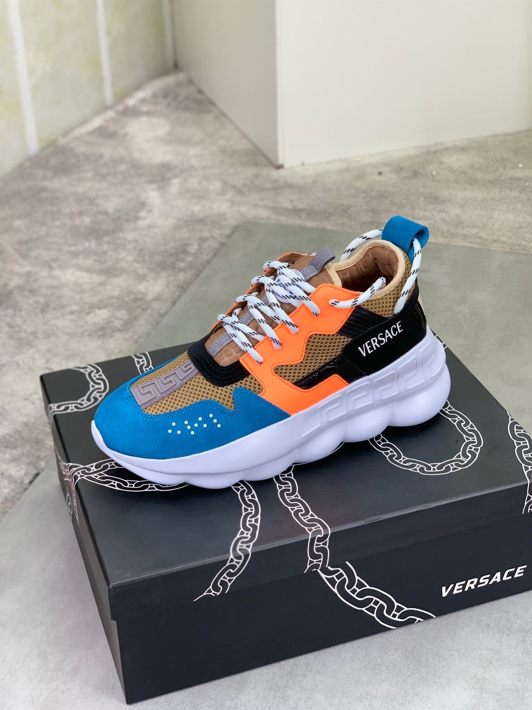 Versace chunky sneakers on box, blue orange and black with white platform sole