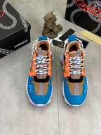 Pair of Versace sneakers in blue, orange, black, with white laces and beige lining