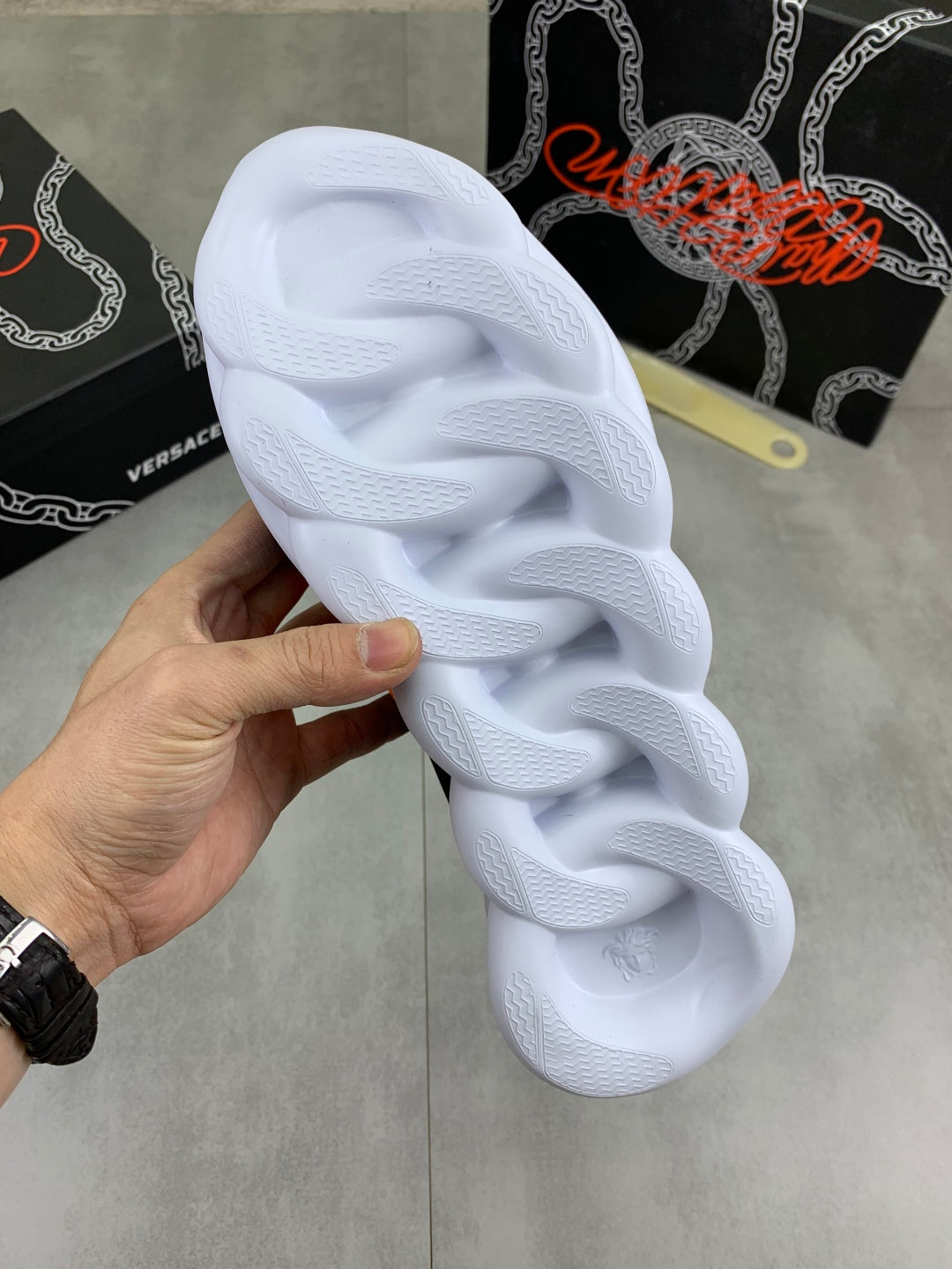 Versace sneakers outsole and tread, white chunky sole held in hand