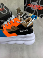 Versace sneakers close-up from side, black orange blue upper with white platform sole