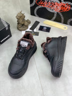 Luxury Versace dark gray high-top sneakers with taupe faux-fur lining and lace-up closure.