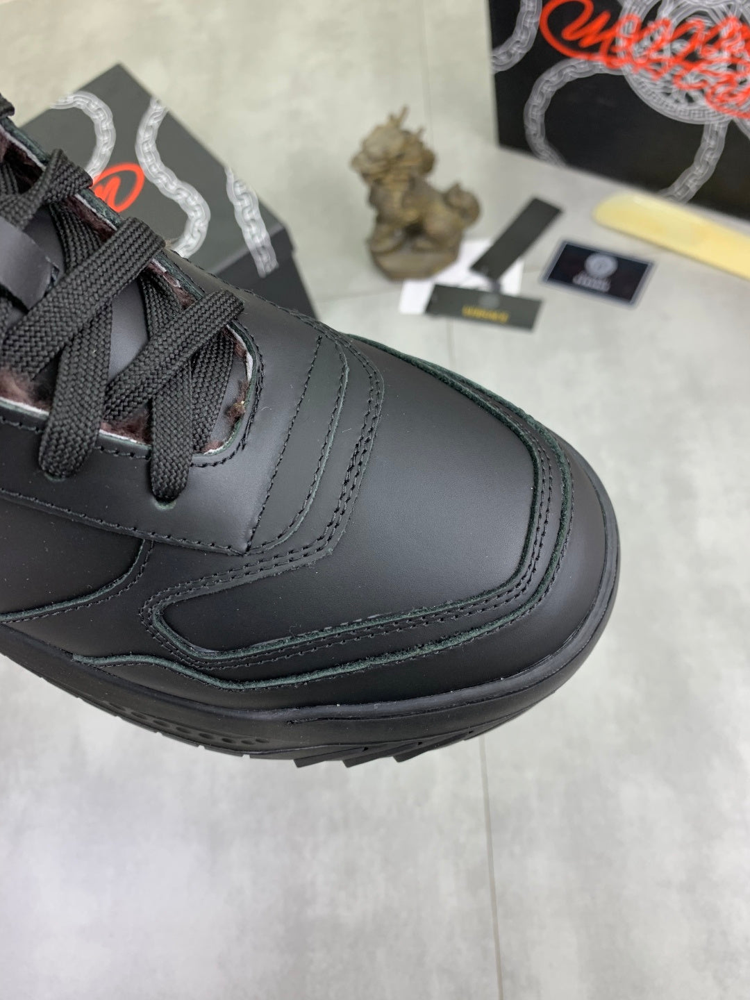 Versace dark gray sneaker toe and side, lace-up with stitched panel details