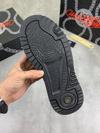 Luxury Versace dark gray sneaker outsole view with rugged tread and circular logo.