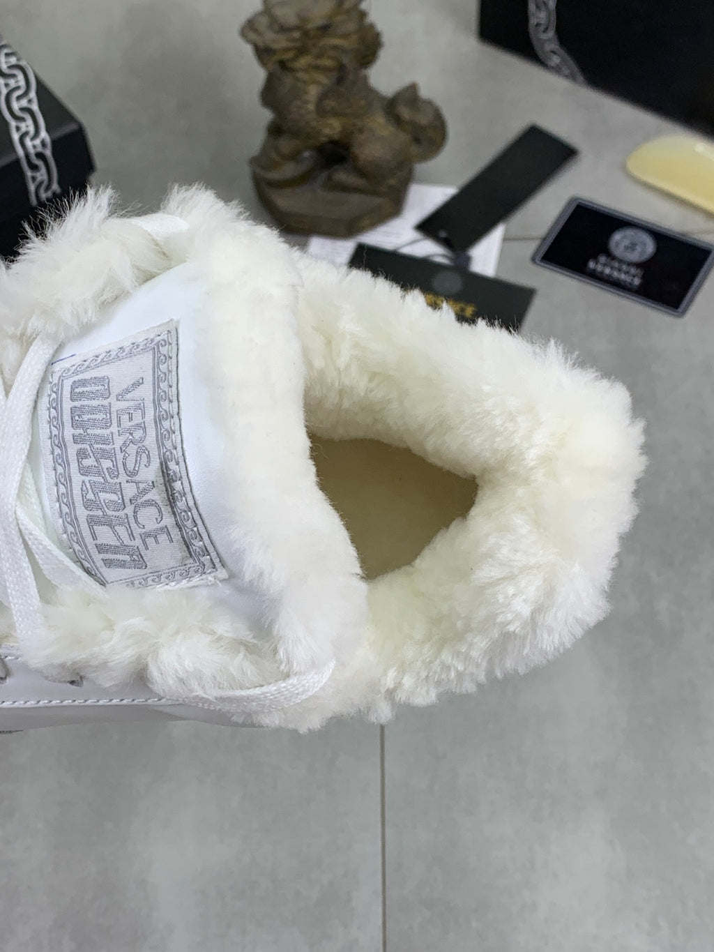 Versace white sneaker interior showing fuzzy lining at the opening