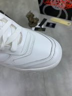 Versace white leather sneaker side view with stitched panels and laces
