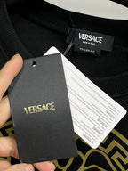Versace crewneck sweatshirt black with clothing tag reading VERSACE and size info