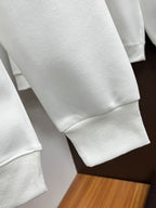 White crewneck sweatshirt sleeve with ribbed cuff detail