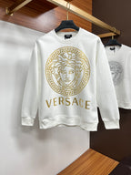 White crewneck sweatshirt with gold Medusa face and Greek key emblem front