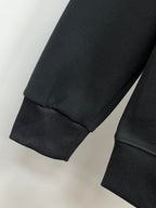Black sweatshirt with ribbed sleeve cuff and straight hem