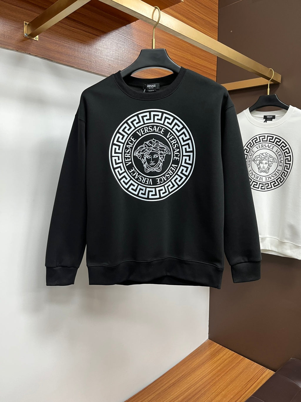 Black crewneck sweatshirt with large circular Versace logo graphic