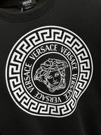 Black crewneck sweatshirt with large circular Greek-key logo and Medusa emblem