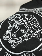 Black sweatshirt fabric with white line-art Medusa head graphic