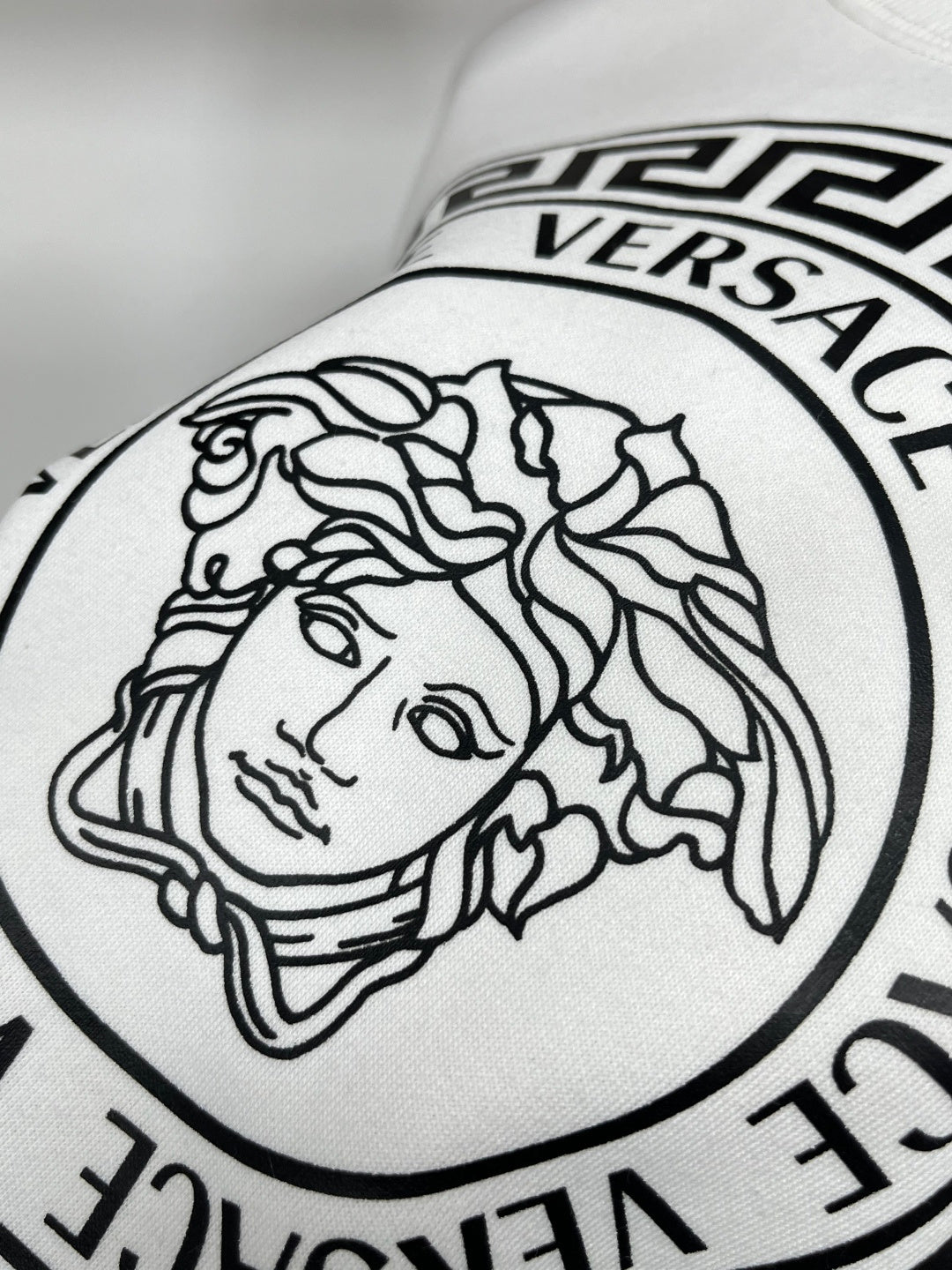 White Versace sweatshirt close-up of Medusa face logo print