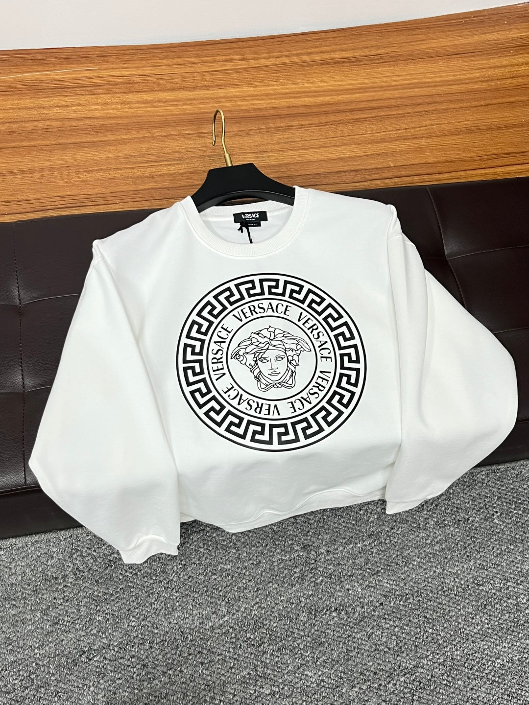 White Versace sweatshirt front view with circular Medusa logo on chest