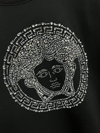 Black crewneck sweatshirt with detailed jeweled face emblem graphic