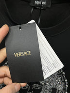 Versace black sweatshirt hangtag on neckline, fabric label visible