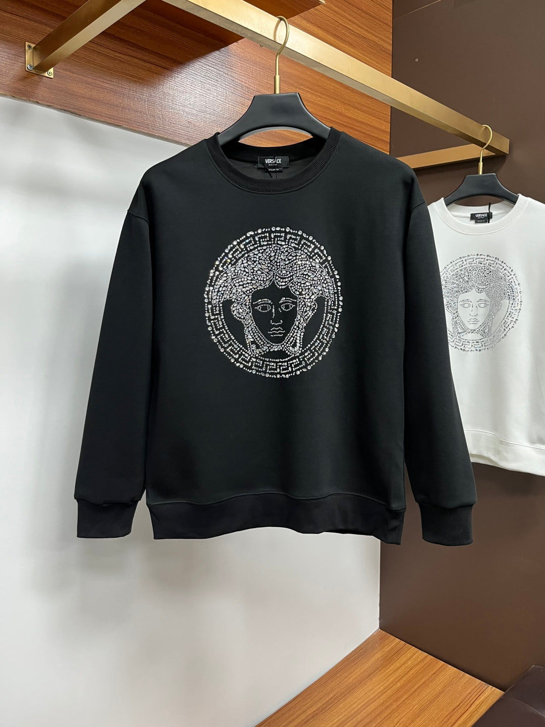 Black crewneck sweatshirt with jeweled face logo print
