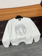 Versace white crewneck sweatshirt on hanger with rhinestone Medusa face graphic