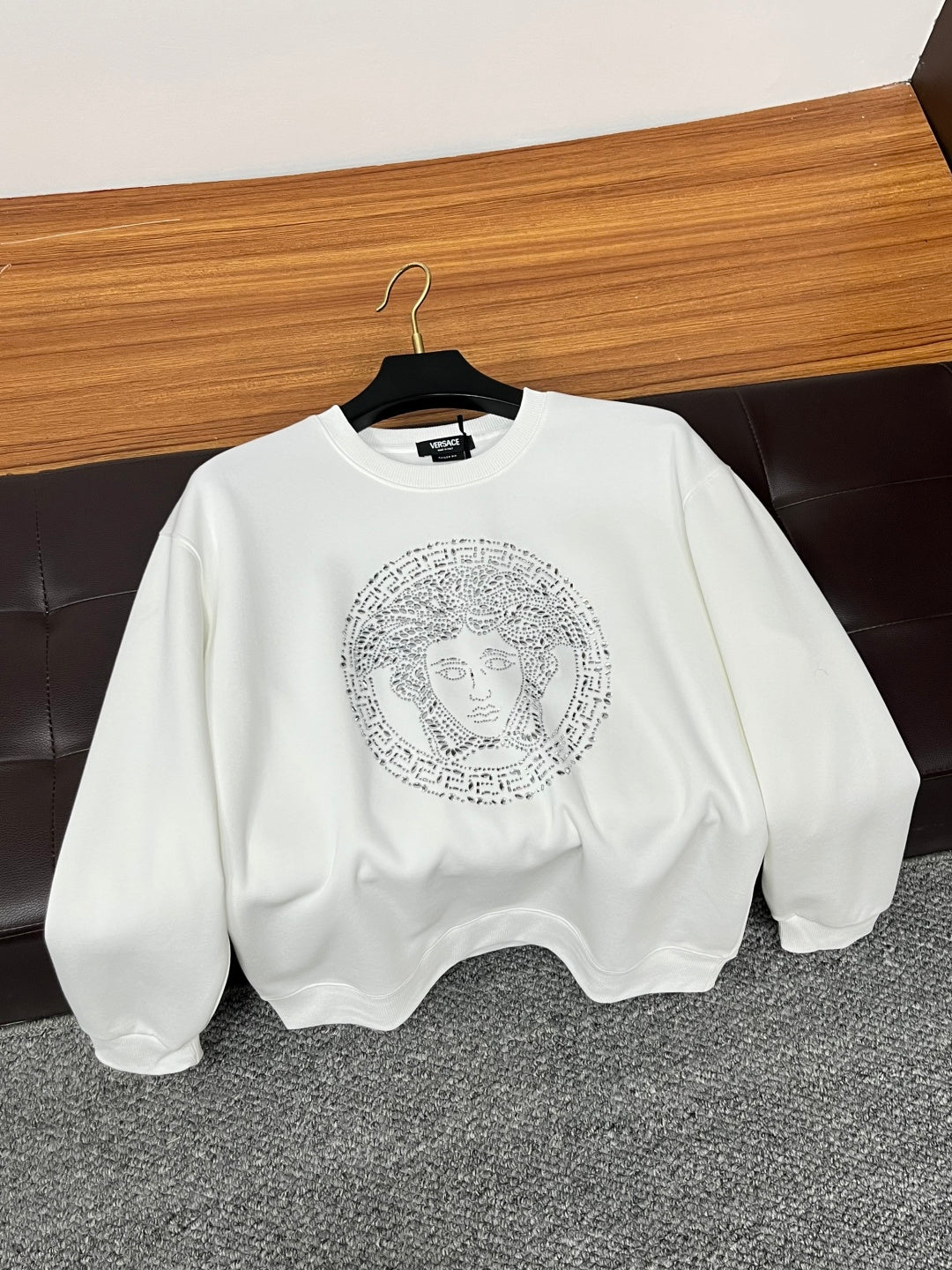 Versace white crewneck sweatshirt on hanger with rhinestone Medusa face graphic