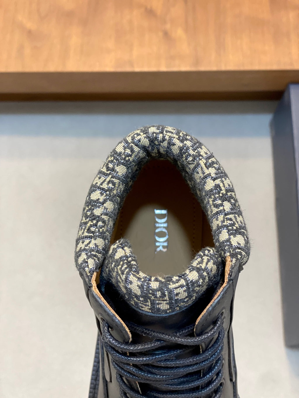 Boot tongue and collar detail in patterned fabric with lace-up front