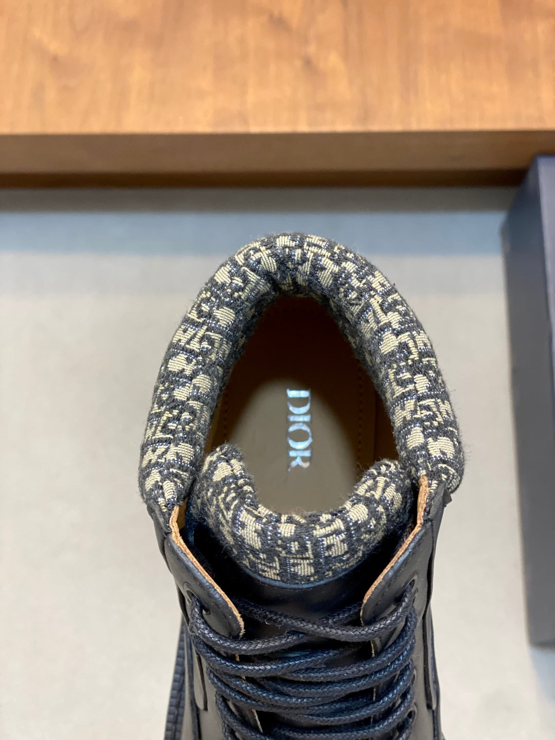 Boot tongue and collar detail in patterned fabric with lace-up front