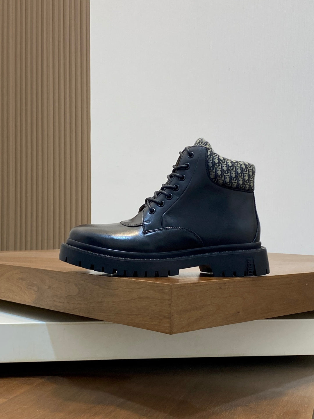 Dark high-top lace-up boots with patterned knit collar and rubber lug sole