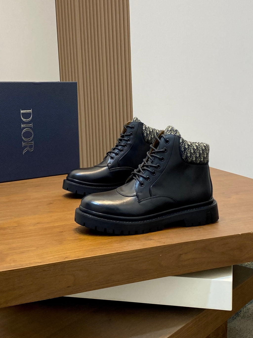 Pair of dark lace-up leather ankle boots with patterned collar and black platform sole