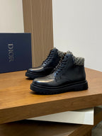 Pair of dark lace-up leather ankle boots with patterned collar and black platform sole