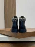 Back view of dark lace-up ankle boots with patterned heel collar and treaded soles