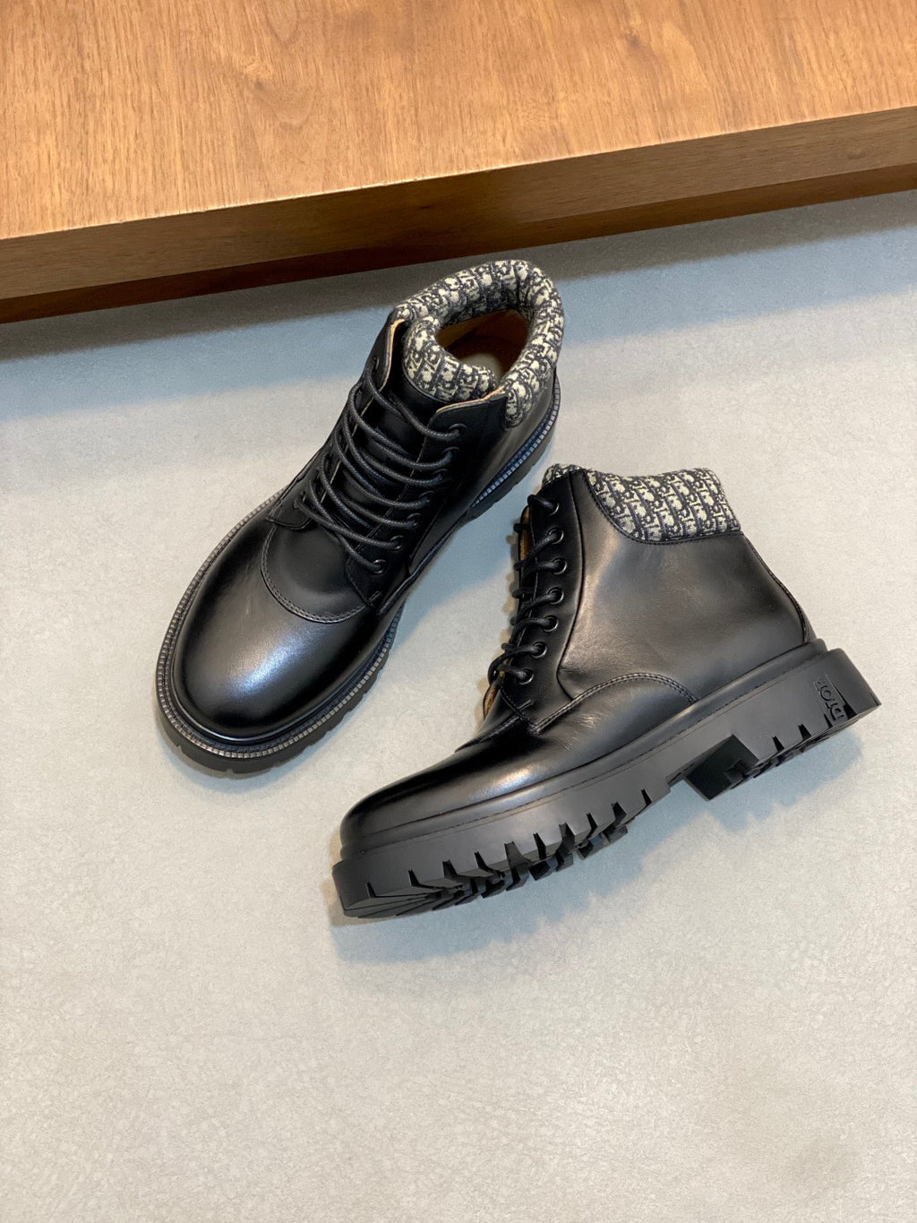 Two-tone dark lace-up boots with patterned collar and thick black rubber outsoles