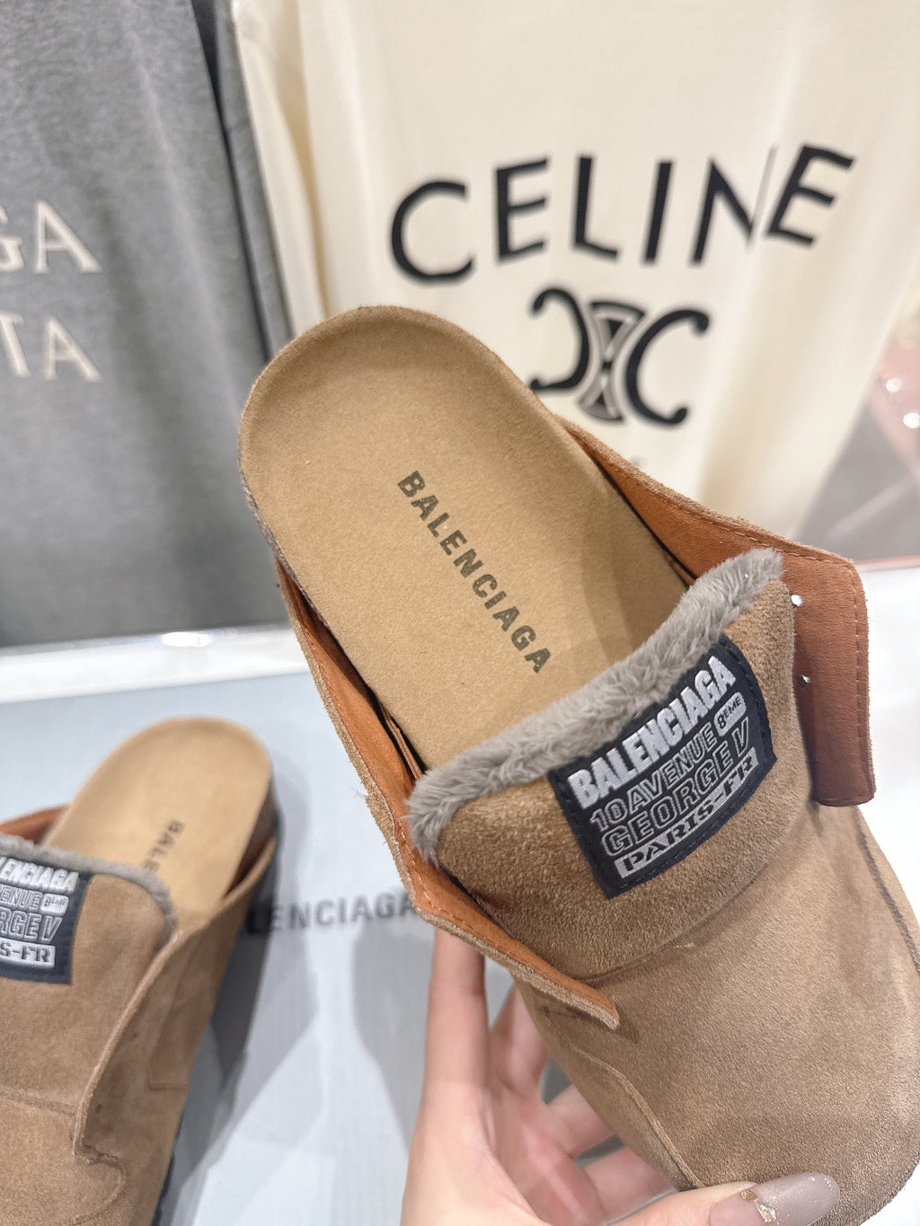 Brown suede slip-on sandal with Balenciaga label and gray shearling trim