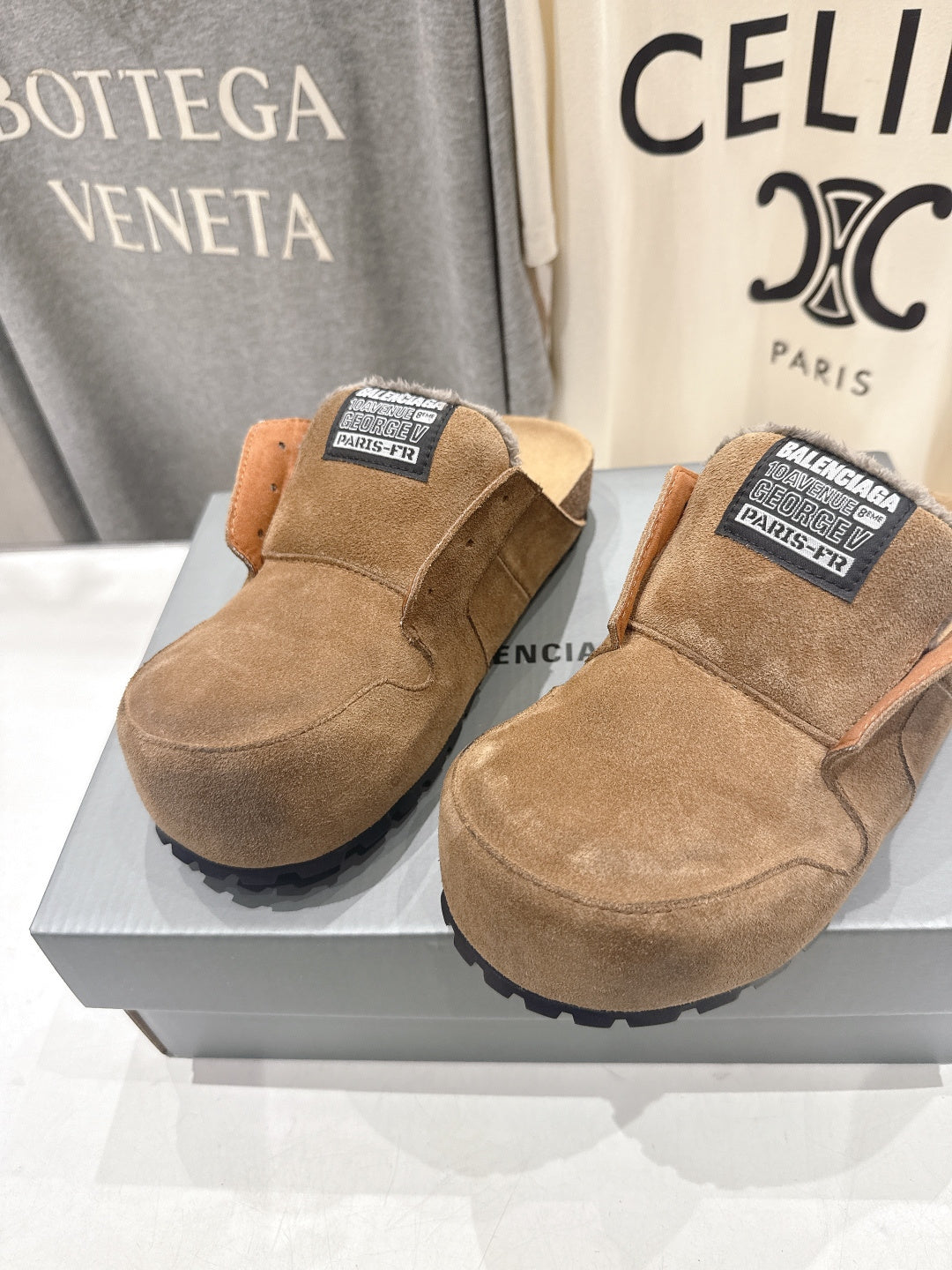 Pair of brown suede slip-on sandals with shearling lining and Balenciaga labels