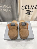 Brown suede slip-on sandals with shearling lining and Balenciaga label on top