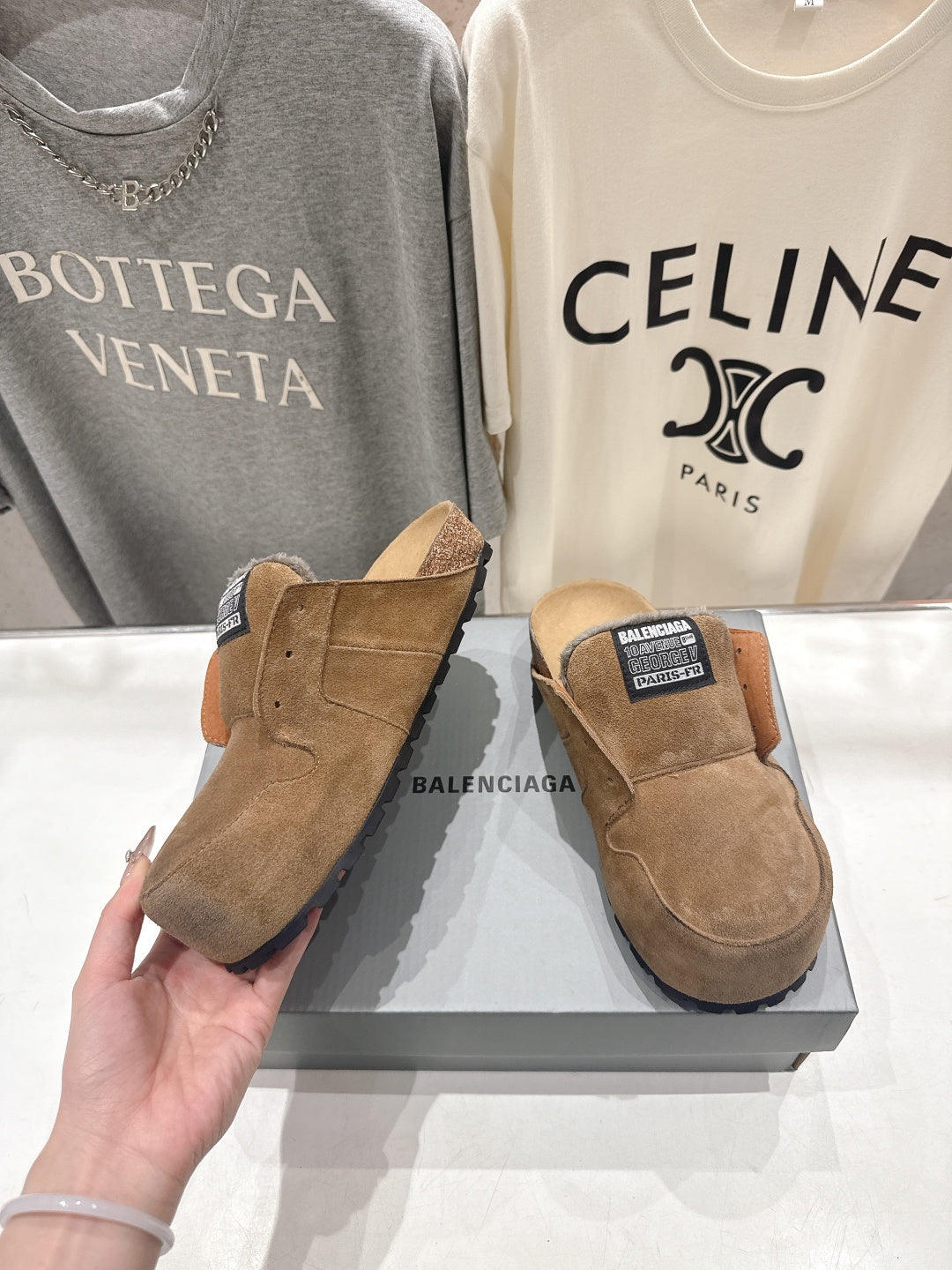 Brown suede slip-on sandals with shearling lining and angled side view