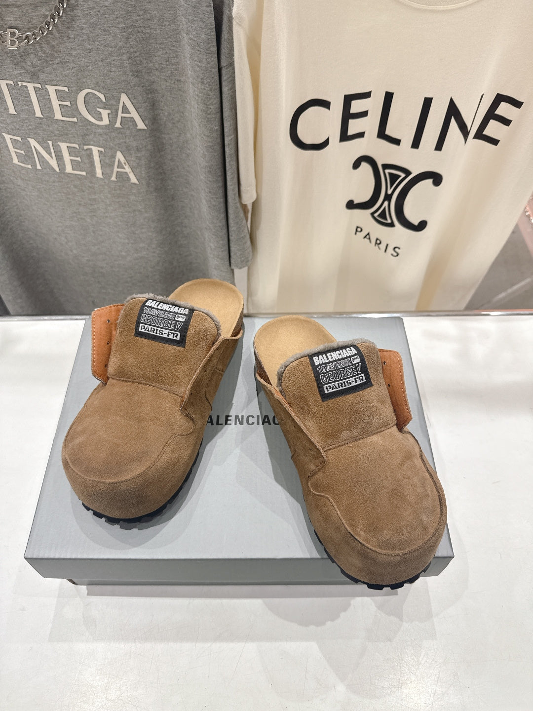 Pair of brown suede slip-on sandals with shearling lining and Balenciaga top label