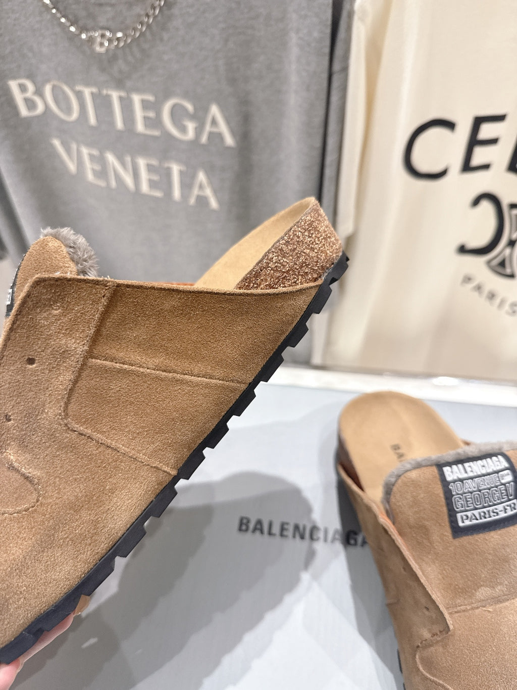 Brown suede slide sandals with shearling lining and rugged tread sole
