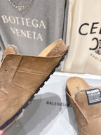 Brown suede slide sandals with shearling lining and rugged tread sole