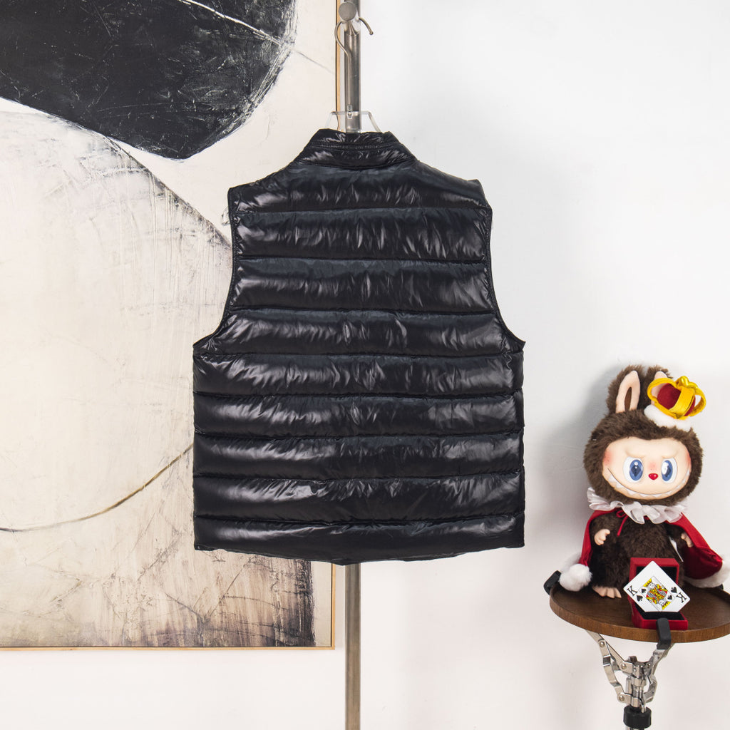 Black quilted sleeveless puffer vest with high collar and horizontal stripes