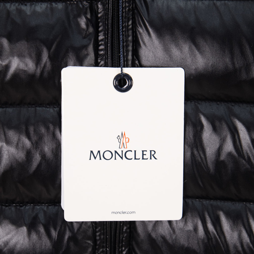 Moncler logo hang tag on black puffer vest