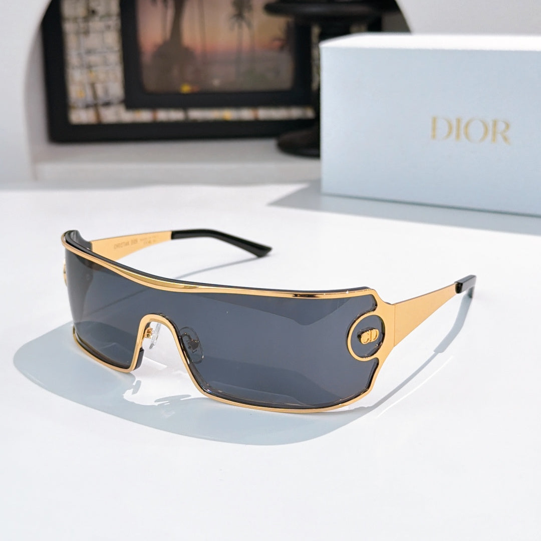 Dior sunglasses with dark blue tinted lenses and gold-trim frame