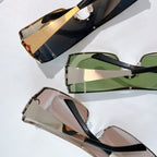 Dior sunglasses set with green and brown lenses, black temples