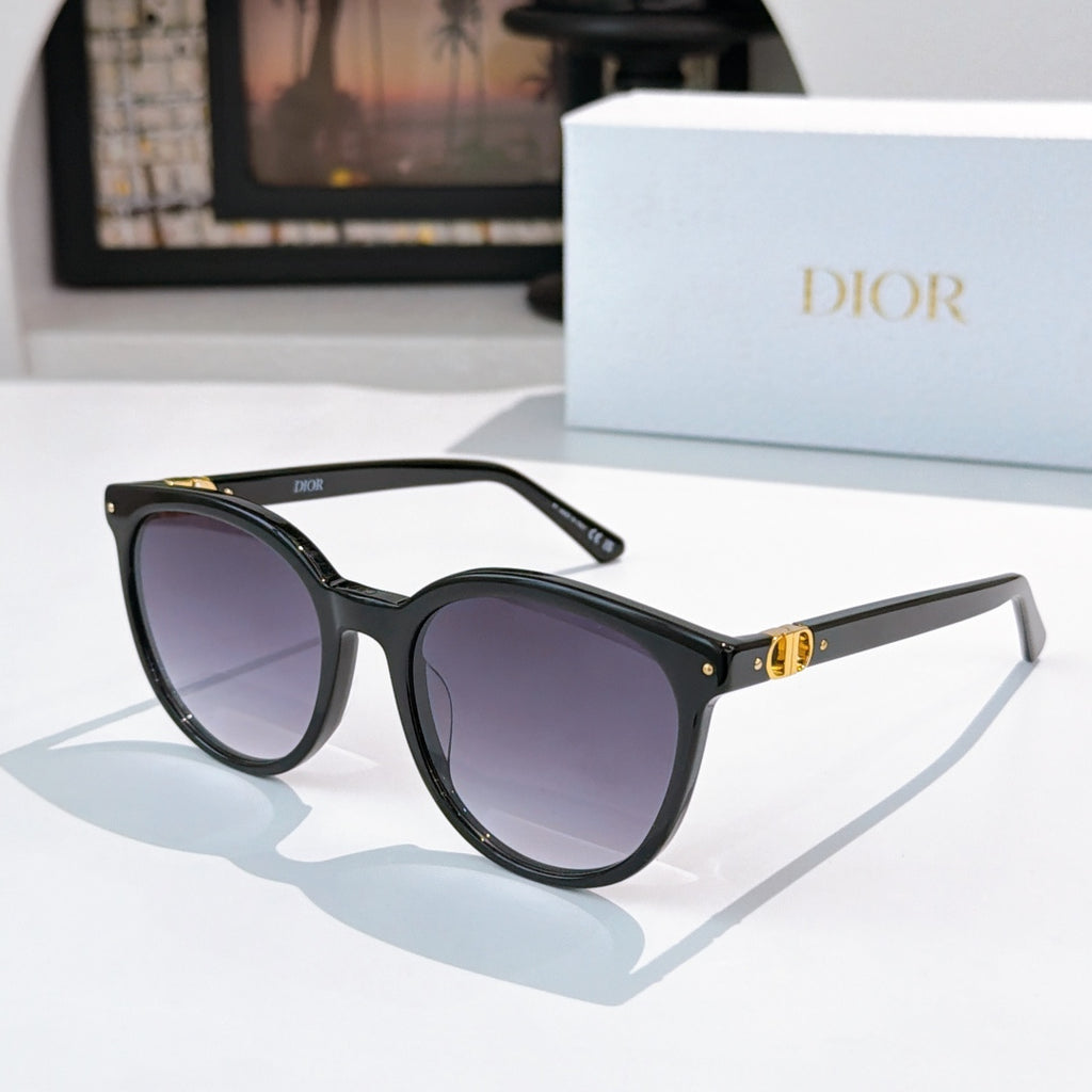 Sunglasses with black frames and purple gradient lenses, gold hinge and logo detail