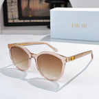 Sunglasses with clear pink frames and beige gradient lenses, gold logo detail on temple