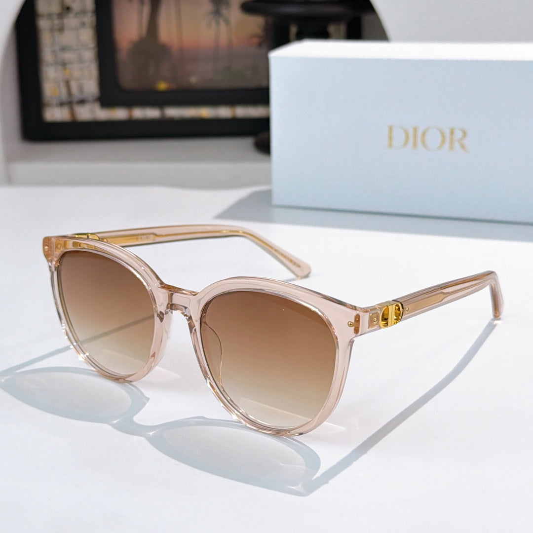 Sunglasses with clear pink frames and beige gradient lenses, gold logo detail on temple