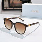 Sunglasses with dark tortoise and black frames, brown gradient lenses, gold hinge detail