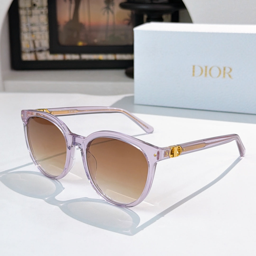 Sunglasses with light purple frames and tan gradient lenses, gold logo detail on temple